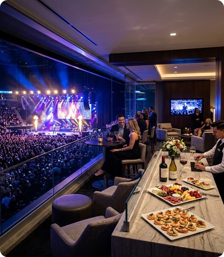Palco VIP con mesa y barra frente al escenario